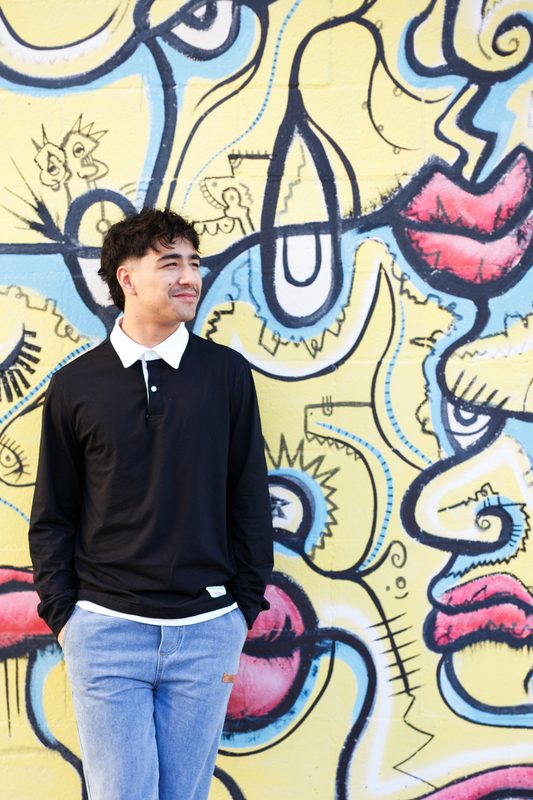 Senior against a bright painted mural