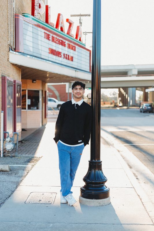 Senior below the old Plaza marquee