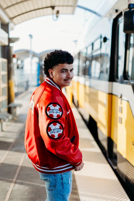 Senior beside a light rail train
