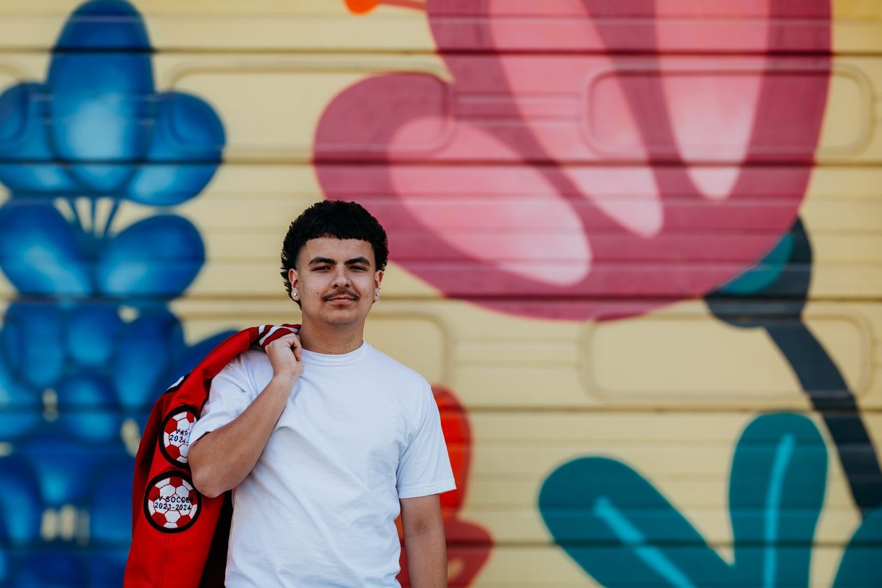 Senior beside painted flowers