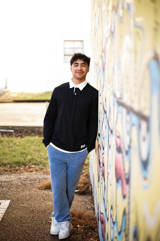Senior beside a painted wall