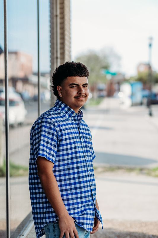 Senior in a checked shirt on the sidewalk