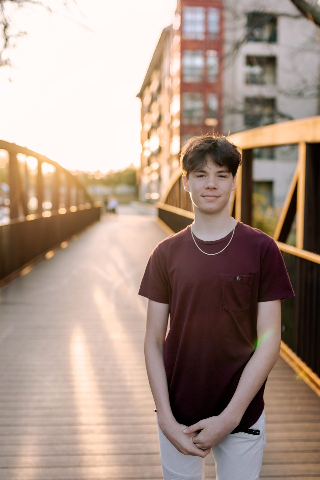Senior on a footbridge at golden hour