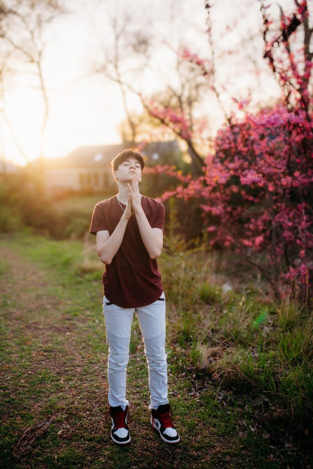 Senior framed by pink spring blossoms