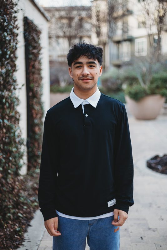 Senior in front of an ivy covered wall