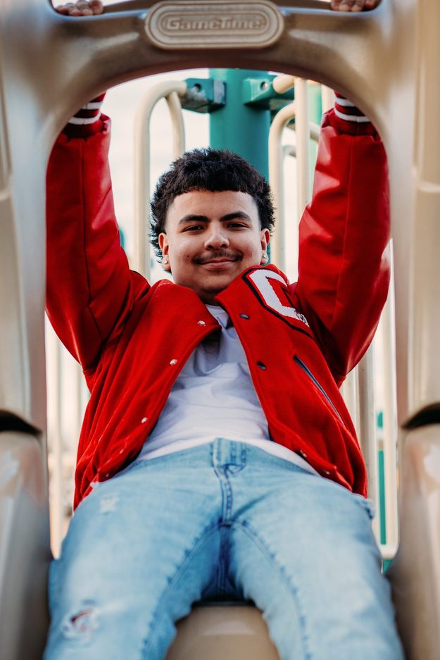 Senior leaning back on a playground slide