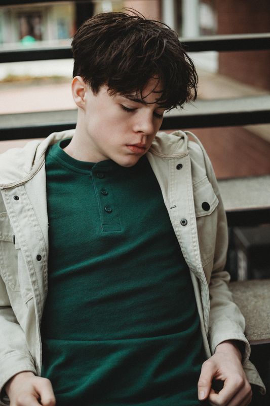 Senior looking down in a green henley