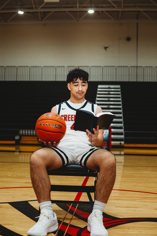 Senior reading in the empty gym