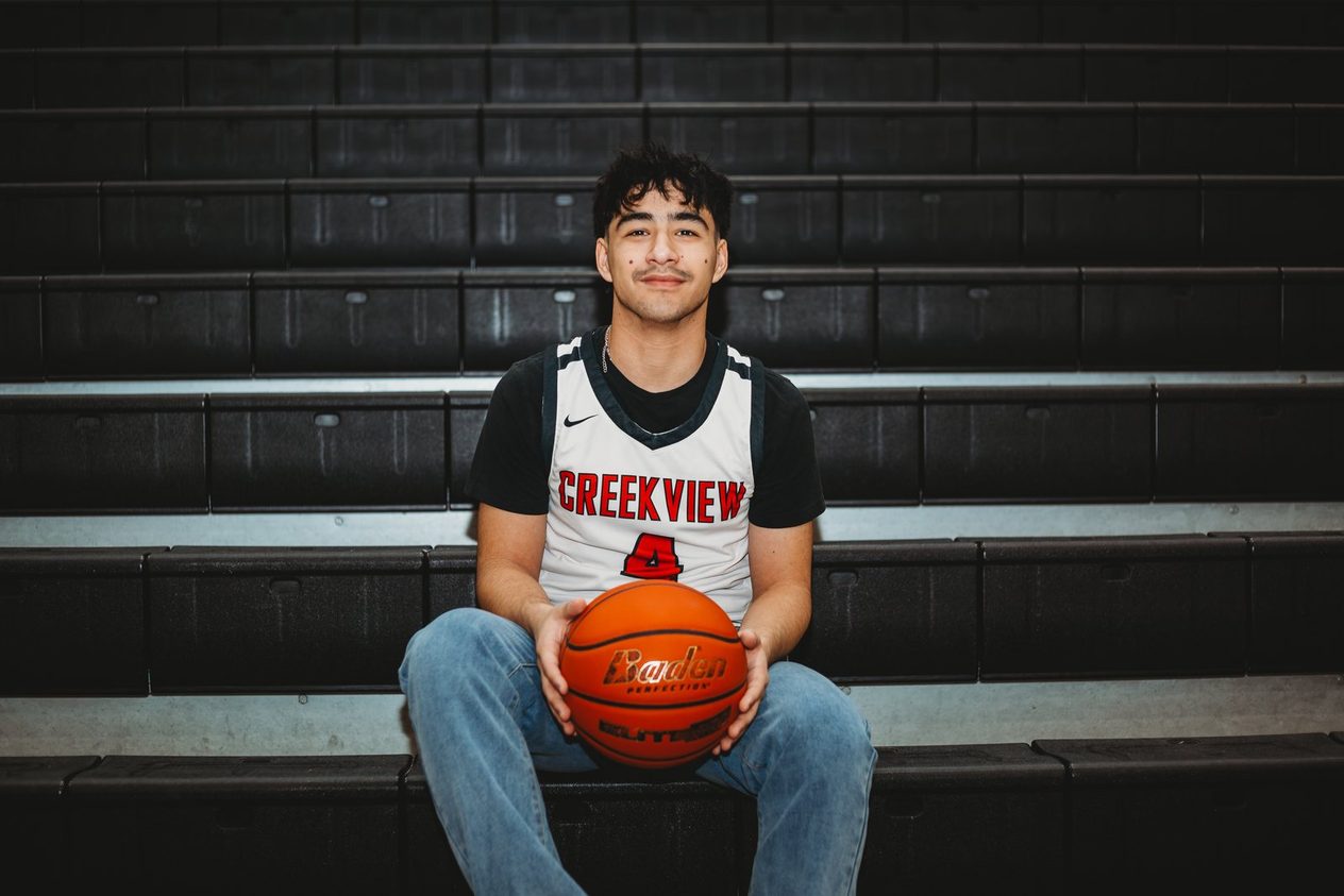 Senior seated on the bleachers