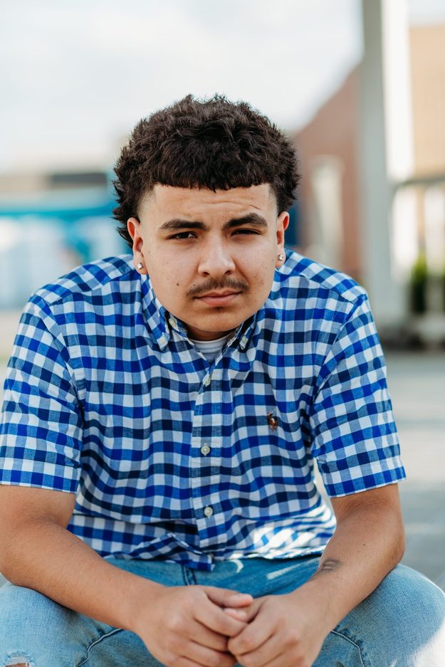 Senior seated in a checked shirt