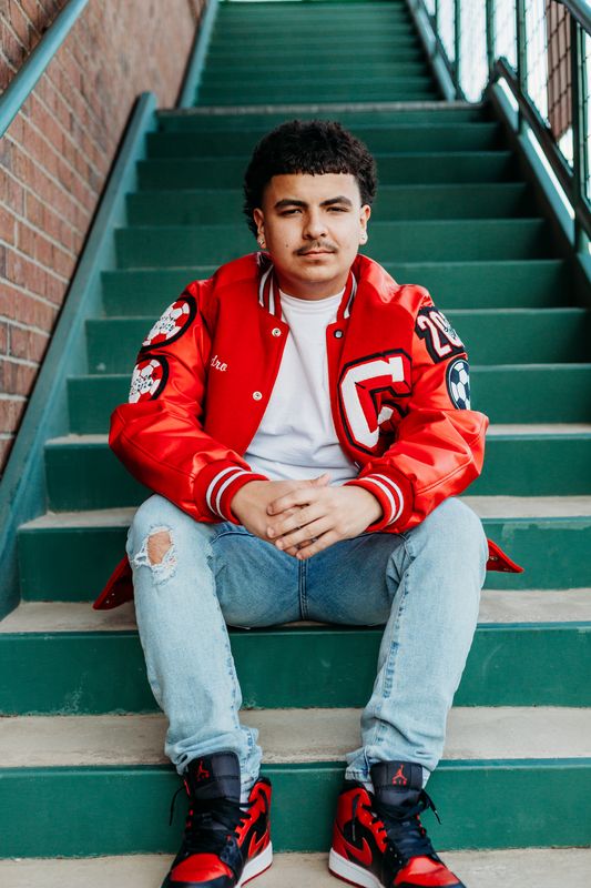 Senior seated on green painted steps