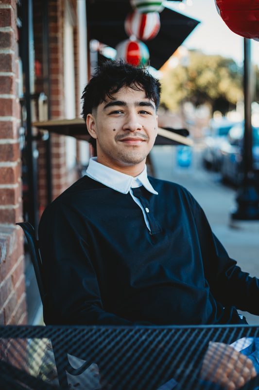 Senior at a sidewalk cafe table