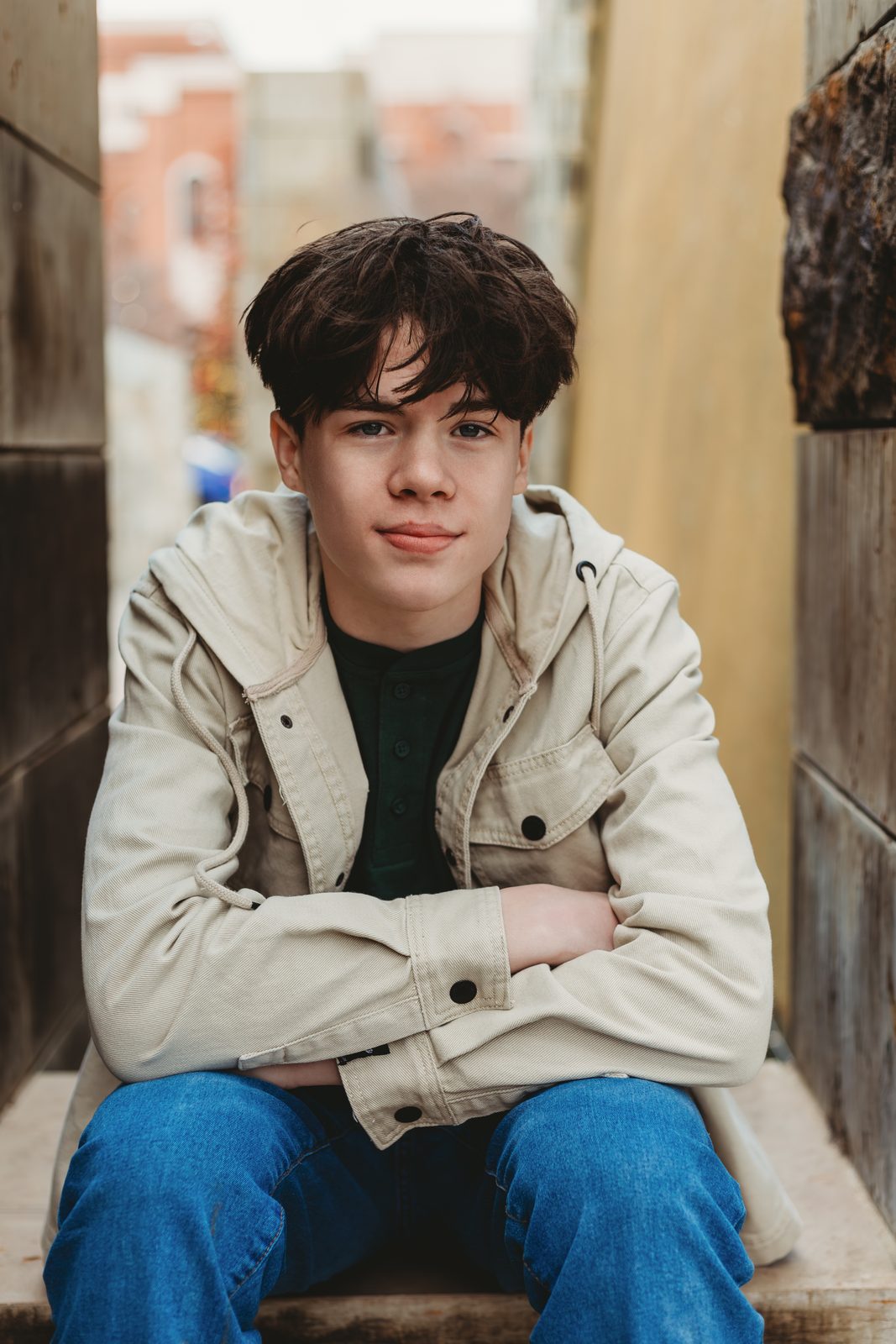 Senior sitting in a narrow alley