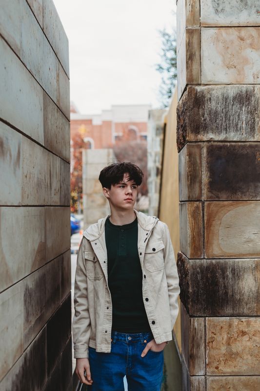 Senior standing between stone columns