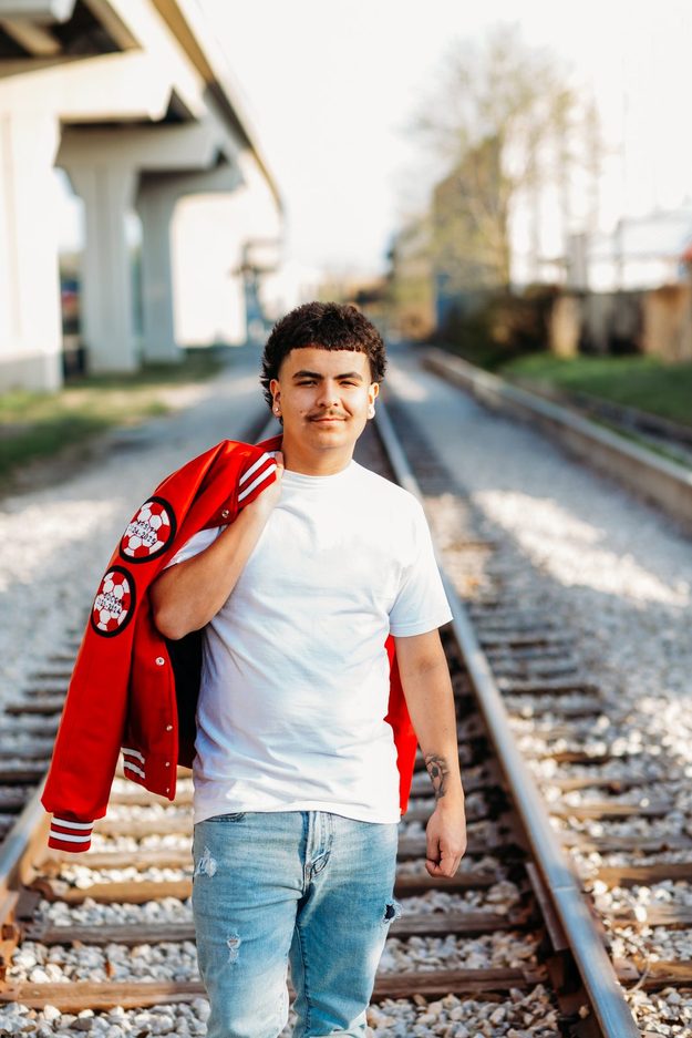 Senior on the tracks with jacket in hand