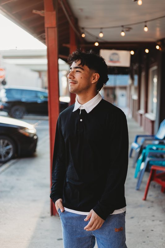 Senior under a shop awning