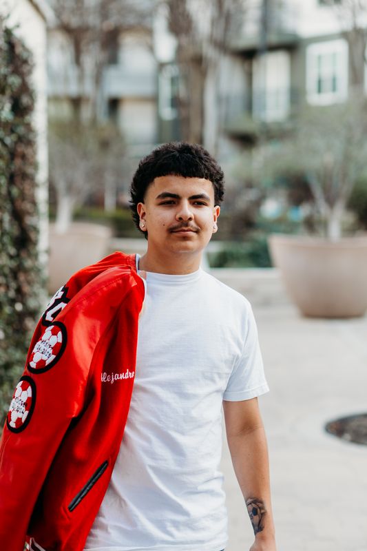 Senior with a red jacket over one shoulder